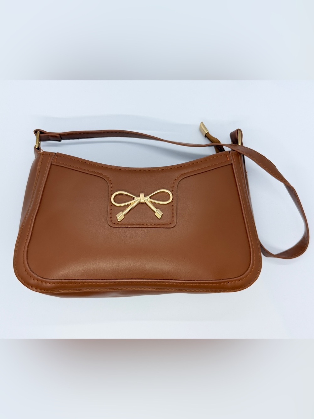 Sleek Brown Shoulder Bag with Gold Bow Emblem